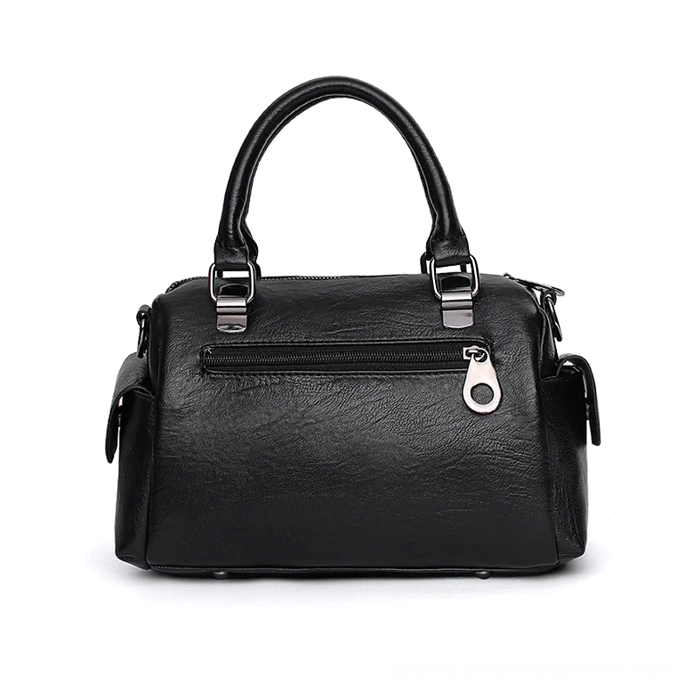Celestial star pendant charm close-up detail on gothic leather handbag - decorative accessory element