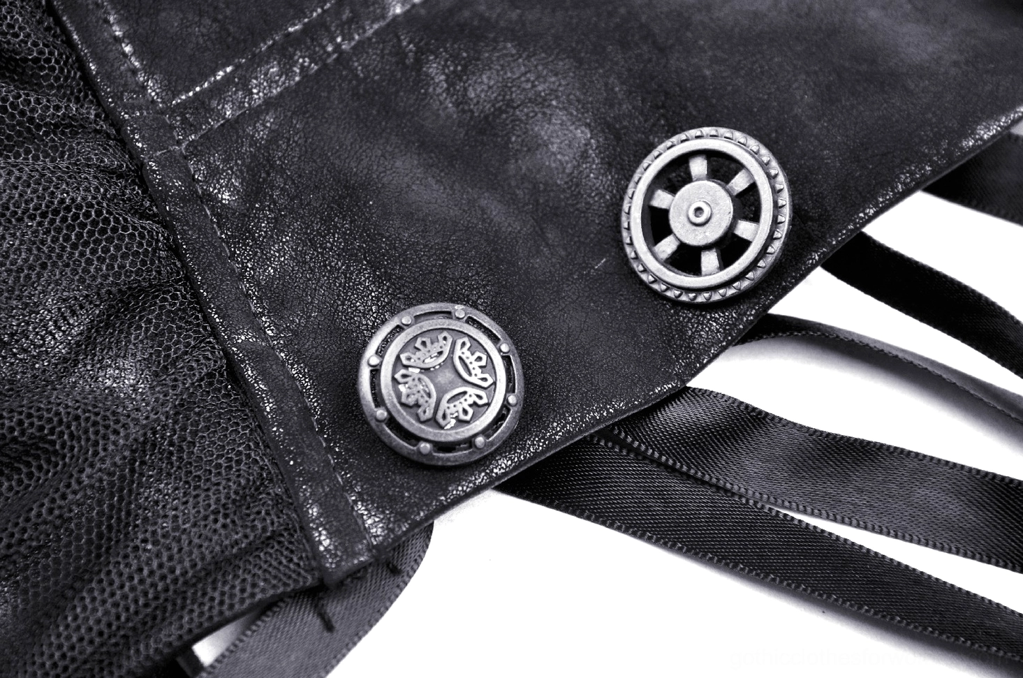 Detailed close-up of steampunk skirt construction showing vintage metal button stitching on distressed black PU leather
