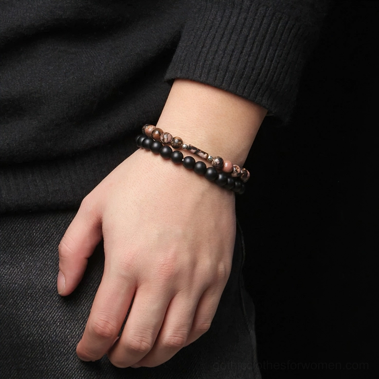 Stone beaded bracelets worn on male wrist, double-layer design with natural gemstones and black accents, side view lifestyle shot
