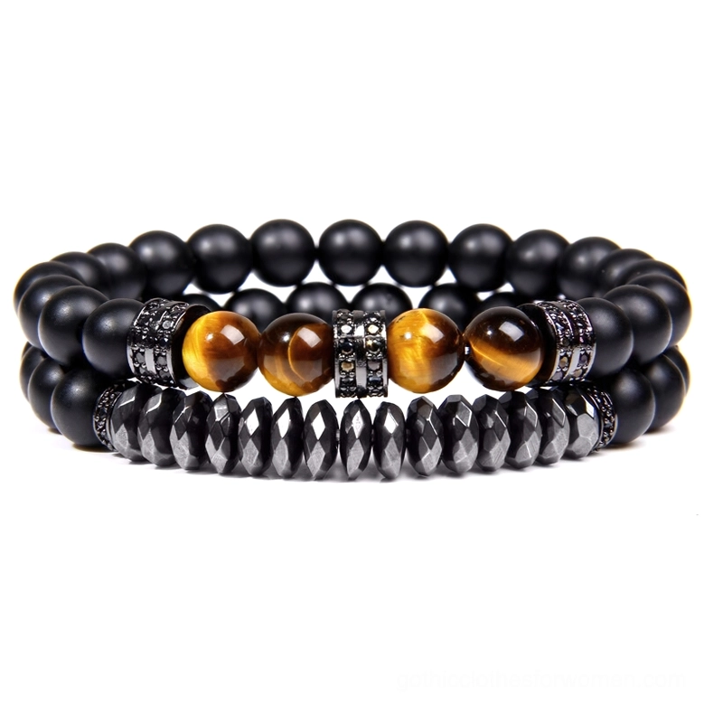 Dark aesthetic beaded bracelet featuring black matte stones, warm yellow tiger eye accent, and silver rhinestone metal spacers
