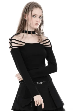 Female model wearing black off-shoulder gothic long sleeve top with strappy cutout shoulders and adjustable snap buckle straps, styled with black choker and dreadlocks, front three-quarter view on white studio background