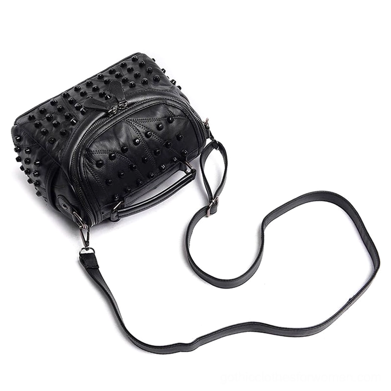 Top oblique view of studded sheepskin leather crossbody bag showing long removable shoulder strap and all-over rivet decoration