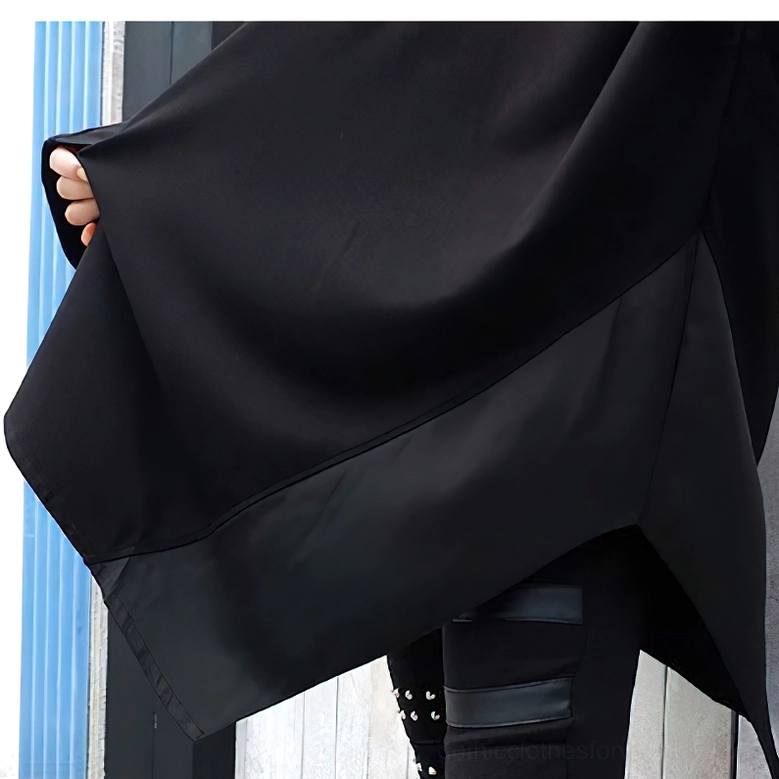 Close-up of asymmetrical hem with premium satin panel on oversized gothic sweatshirt showing texture contrast