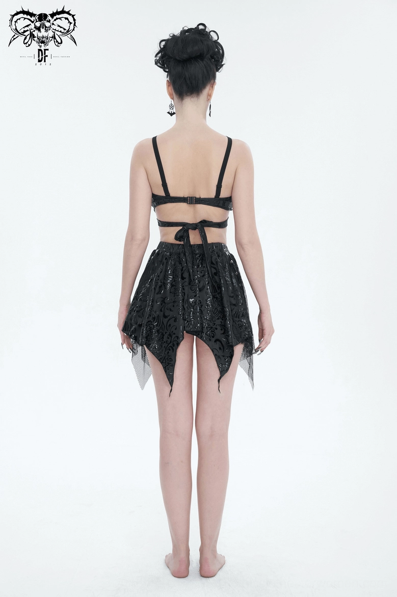 Gothic floral swimsuit detail shot emphasizing star strap construction and metallic cone stud accents
