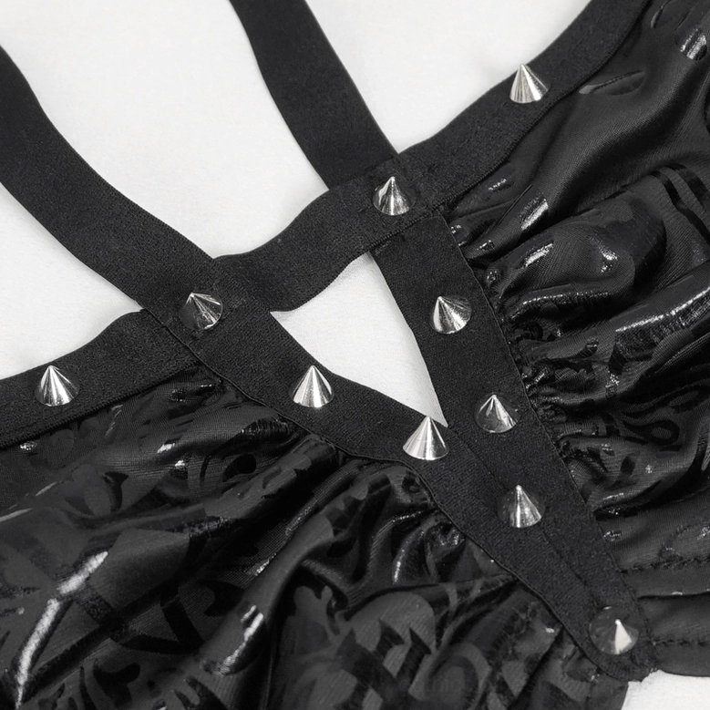 Detailed view of crisscross star straps with multiple silver cone studs on gothic floral swimwear