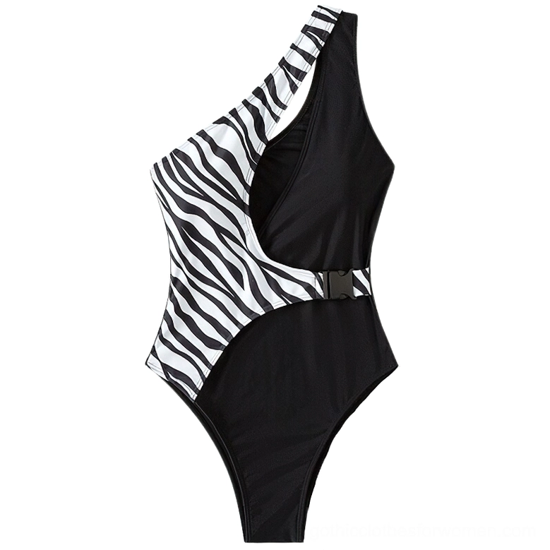 Flat lay detail of zebra print shoulder strap and decorative buckle hardware on gothic swimsuit