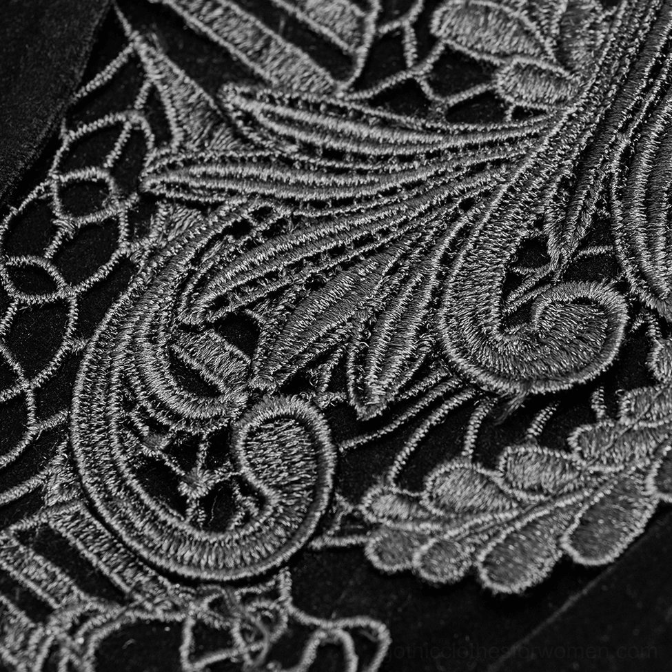 Intricate embroidery detail of Gothic tailcoat chest featuring delicate grey scroll embroidery on black velvet fabric base