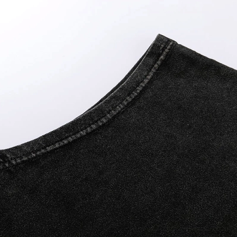 Shoulder seam close-up showing overlocked construction on black gothic tank top