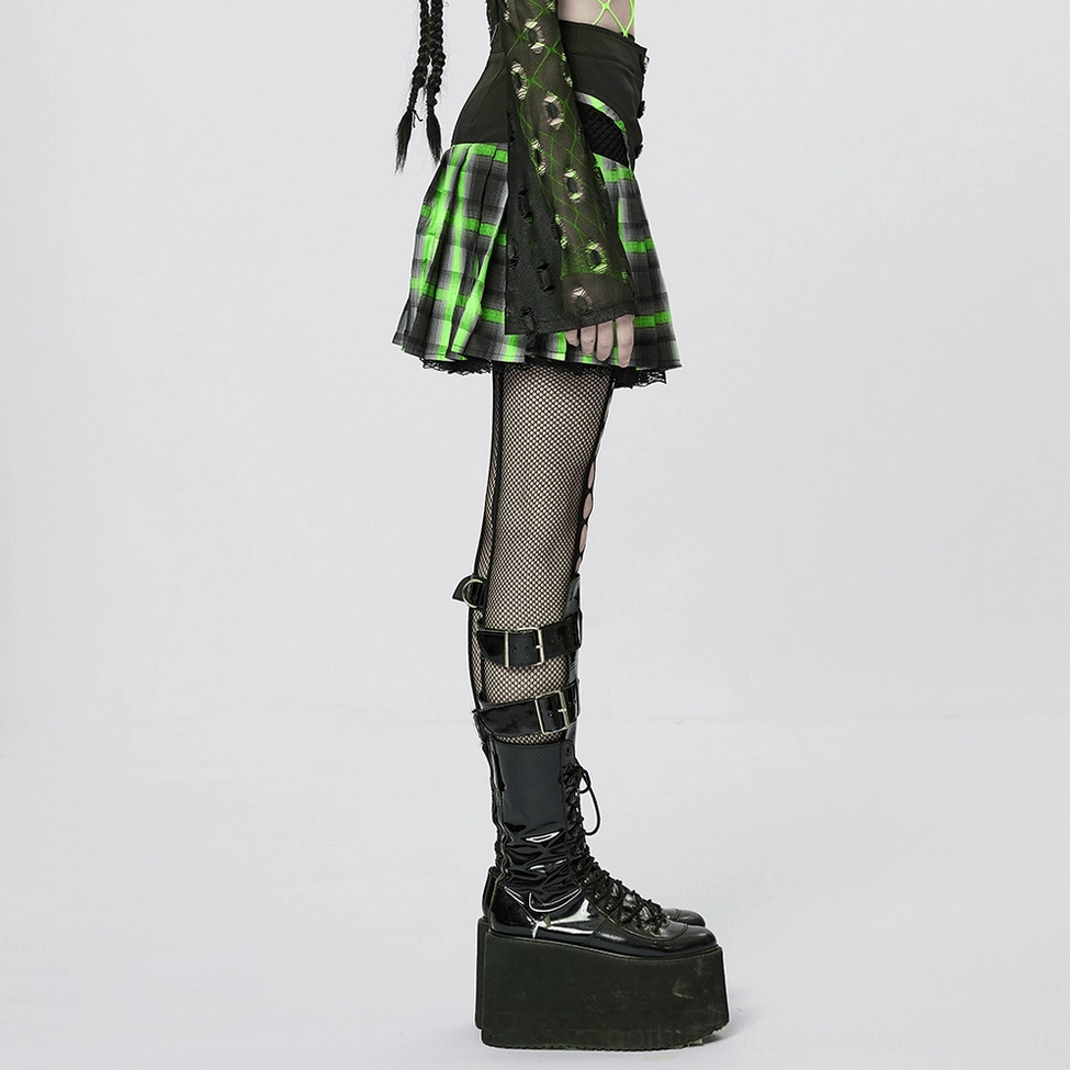 Model wearing black-green pleated tartan gothic skirt displaying cutout detail on sides