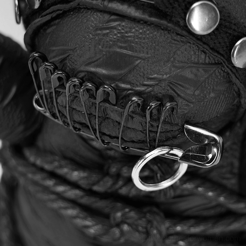 Extreme close-up of gothic teddy bear face featuring stitched mouth, safety pins, and metal hanging ring