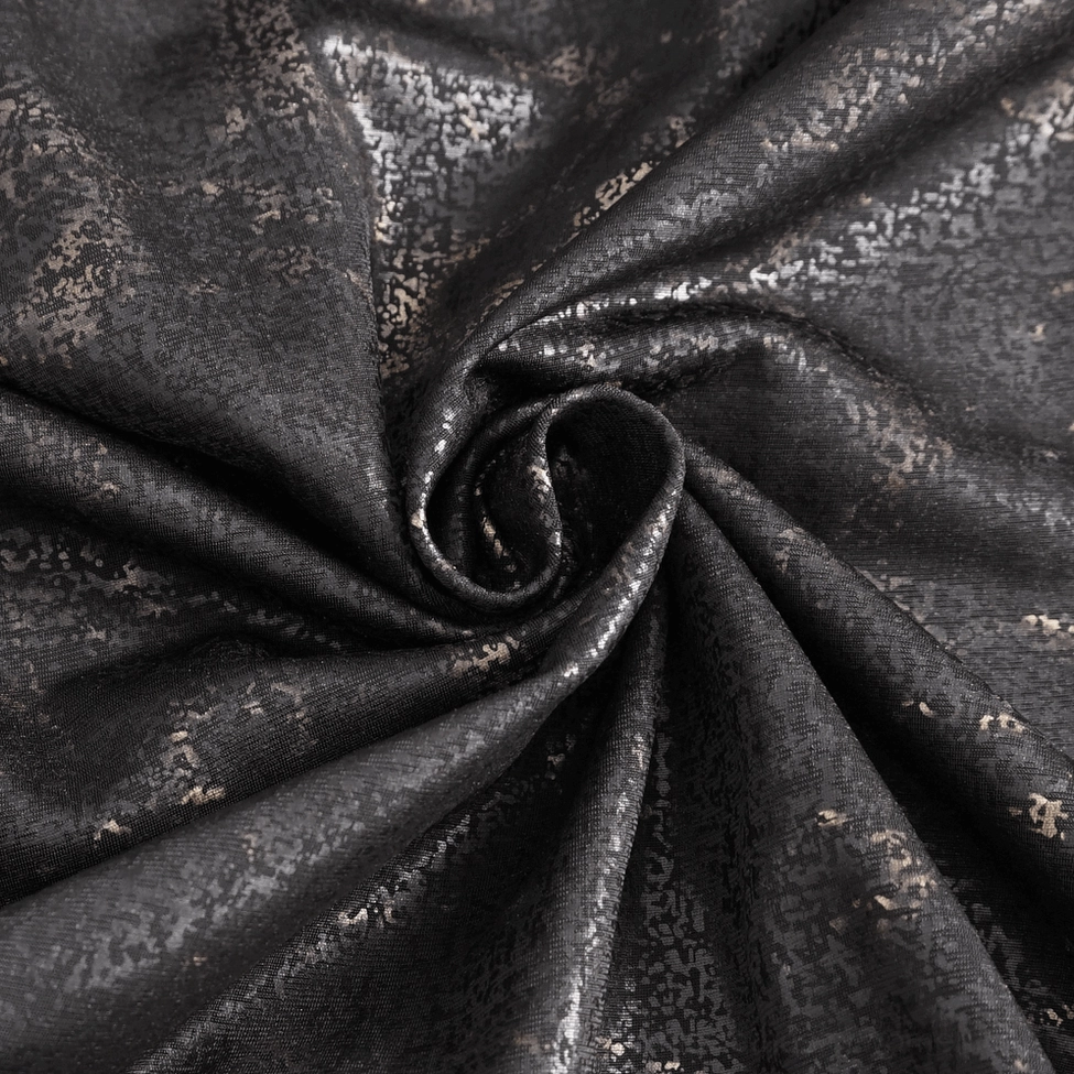 Close-up of gold metallic bronze marble texture print on black gothic t-shirt fabric
