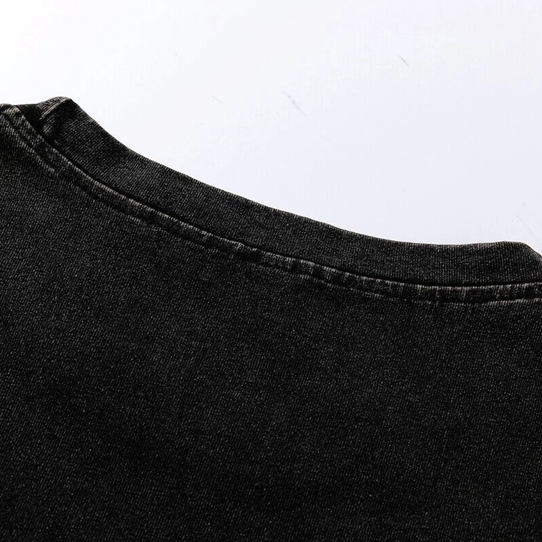 Fabric texture close-up of dense black cotton knit weave showing soft brushed finish and uniform stitched seams on gothic oversized tee