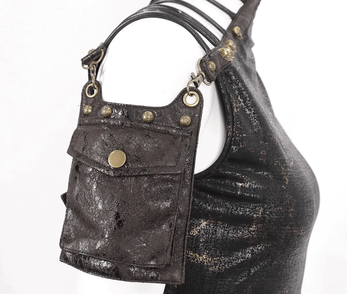 Close-up detail of leather shoulder pocket - brass snap button and skull-shaped rivets