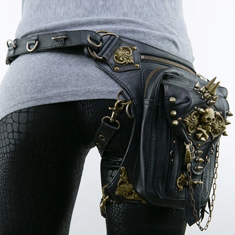 Black leather gothic thigh waist bag worn on lower body with textured leggings showing waist belt fittings and bronze skull details