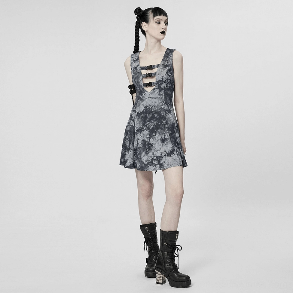 Alternative fashion model wearing gothic tie-dye buckle dress with bold styling and dark aesthetic