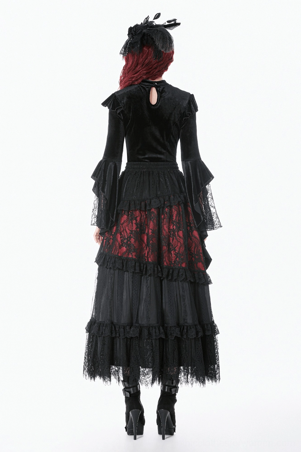 Alternative fashion styling of gothic velvet bell sleeve top paired with dark romance aesthetic clothing