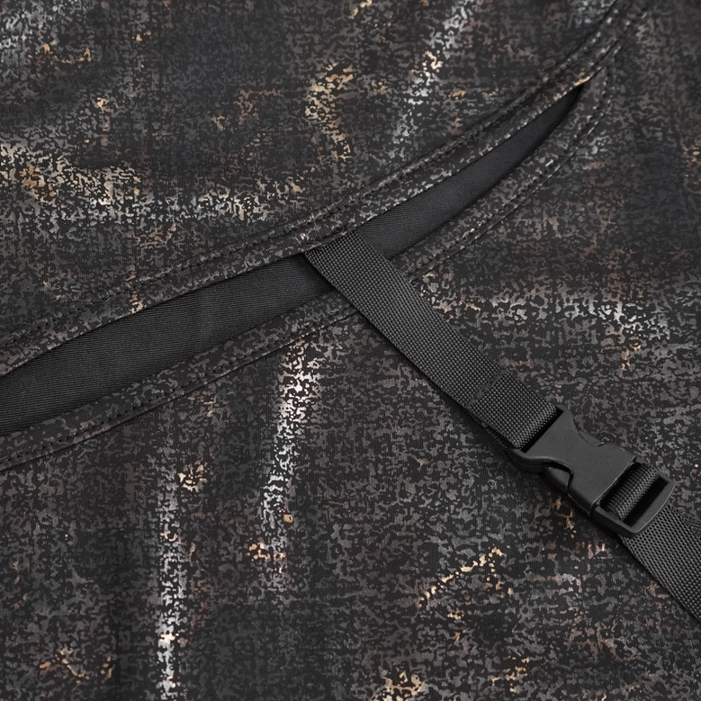 Adjustable nylon buckle strap hardware detail on gothic cutout top's chest opening, close-up view