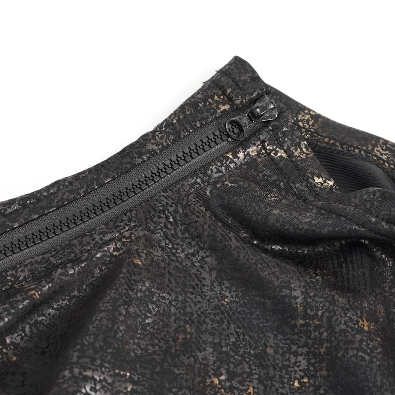 Close-up detail of metal zipper closure on gothic cutout top, distressed metallic fabric texture