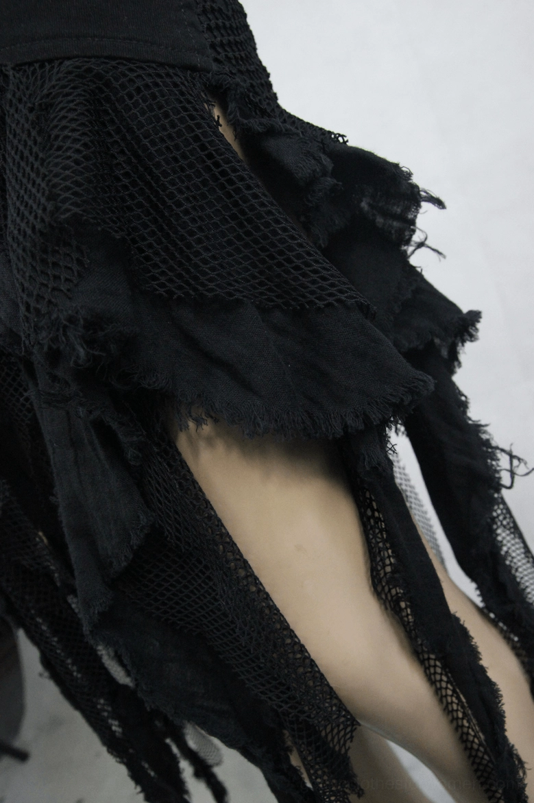 Black gothic skirt hem close-up - layered mesh and frayed fabric tassels detail