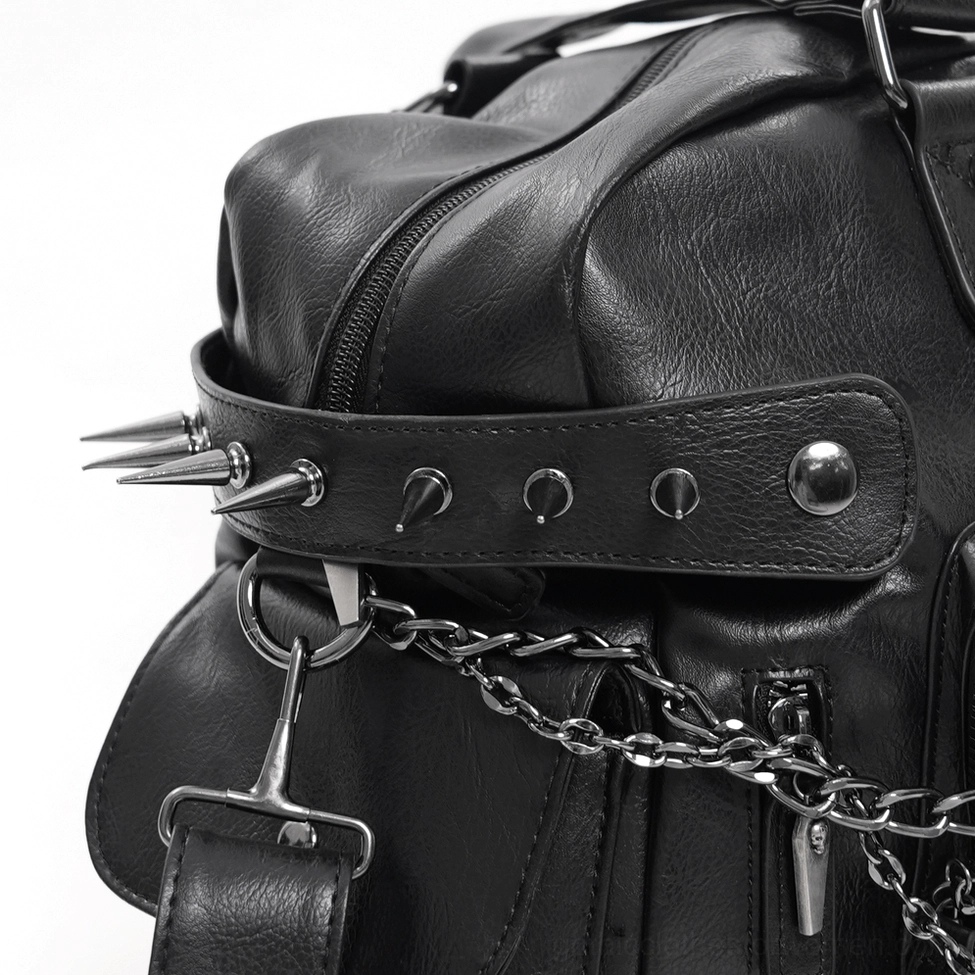 Close-up view of gothic tote bag spike studs, metal hardware, and spiked side pocket construction details
