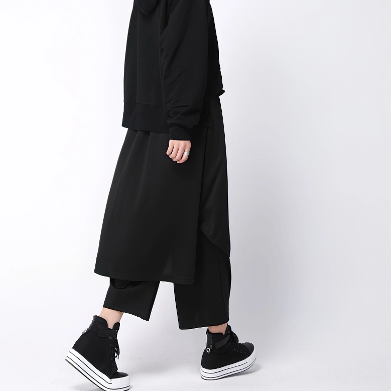 Black gothic cropped pants with asymmetrical back overlay panel, rear side view on model