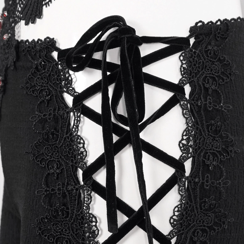 Side lace-up detail close-up of gothic trousers featuring velvet lace-up straps and textured black fabric