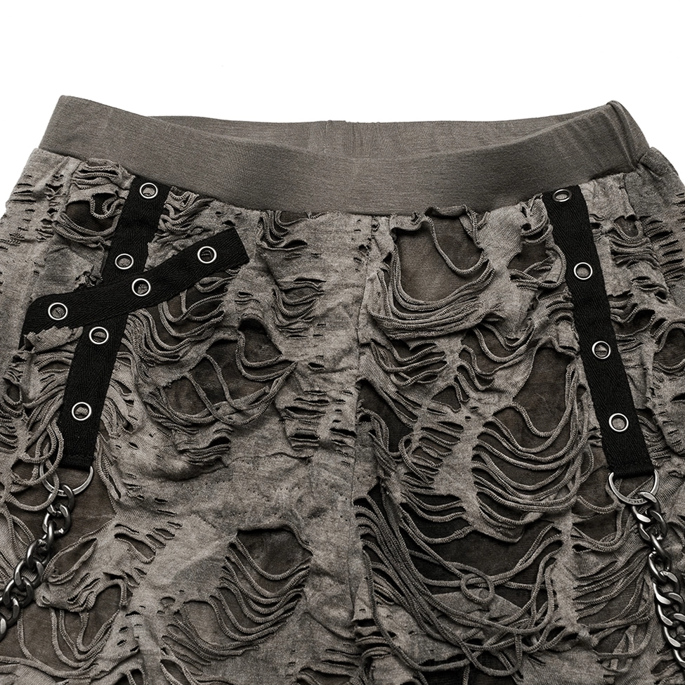 Close-up of gothic trousers waist and strap details featuring metal eyelets, elastic waistband, and small hanging chain