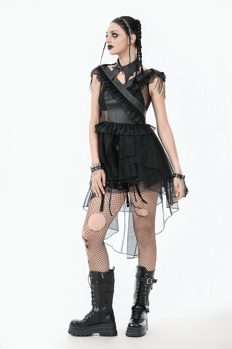 Black gothic tulle dress detail showing cross-wrap neckline design and ruffled shoulder construction