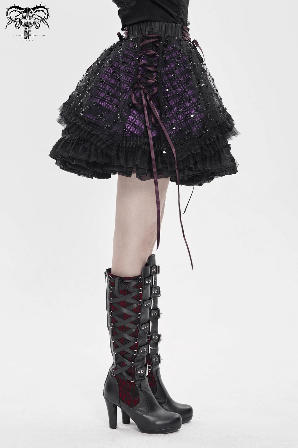Front-facing view of black-purple gothic tulle skirt displaying fitted silhouette, sequin mesh overlay, and corset-style lace-up waist construction