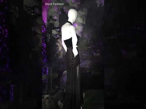 All-black gothic two-piece outfit with halter crop top and matching long skirt, mannequin display side rear view, dark studio backdrop