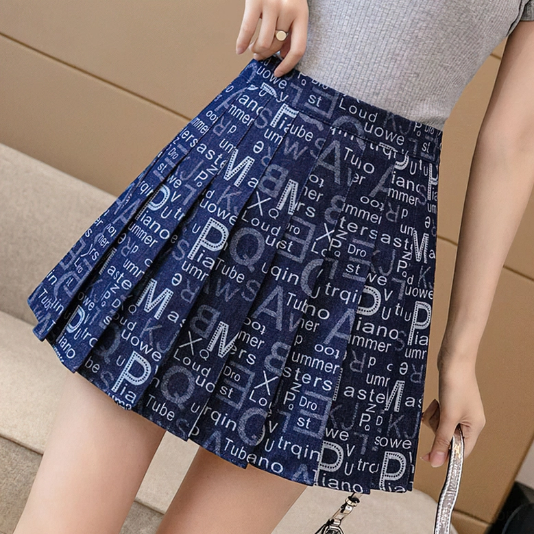 Cobalt blue gothic letter print pleated skirt front worn view, all-over typography on denim mini