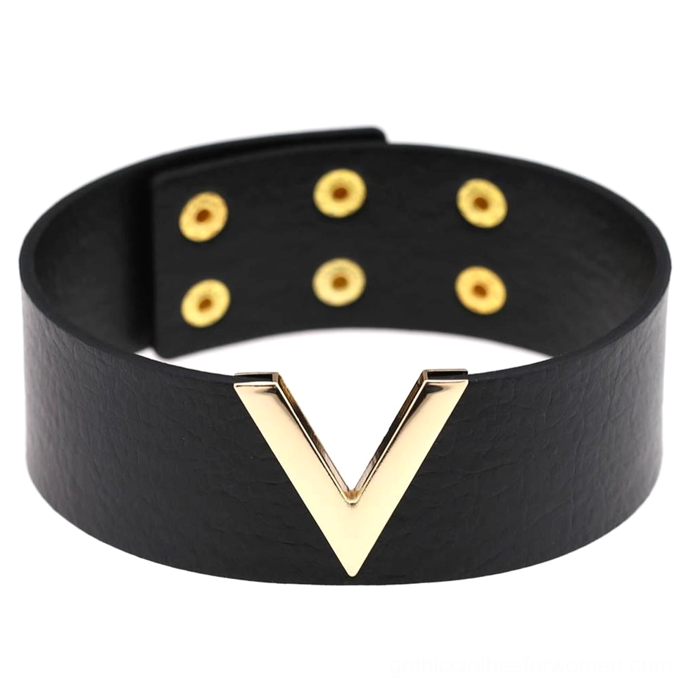 Black leather V-choker with gold hardware, front flat lay view showing geometric V-shaped metal accent and pebbled faux leather texture