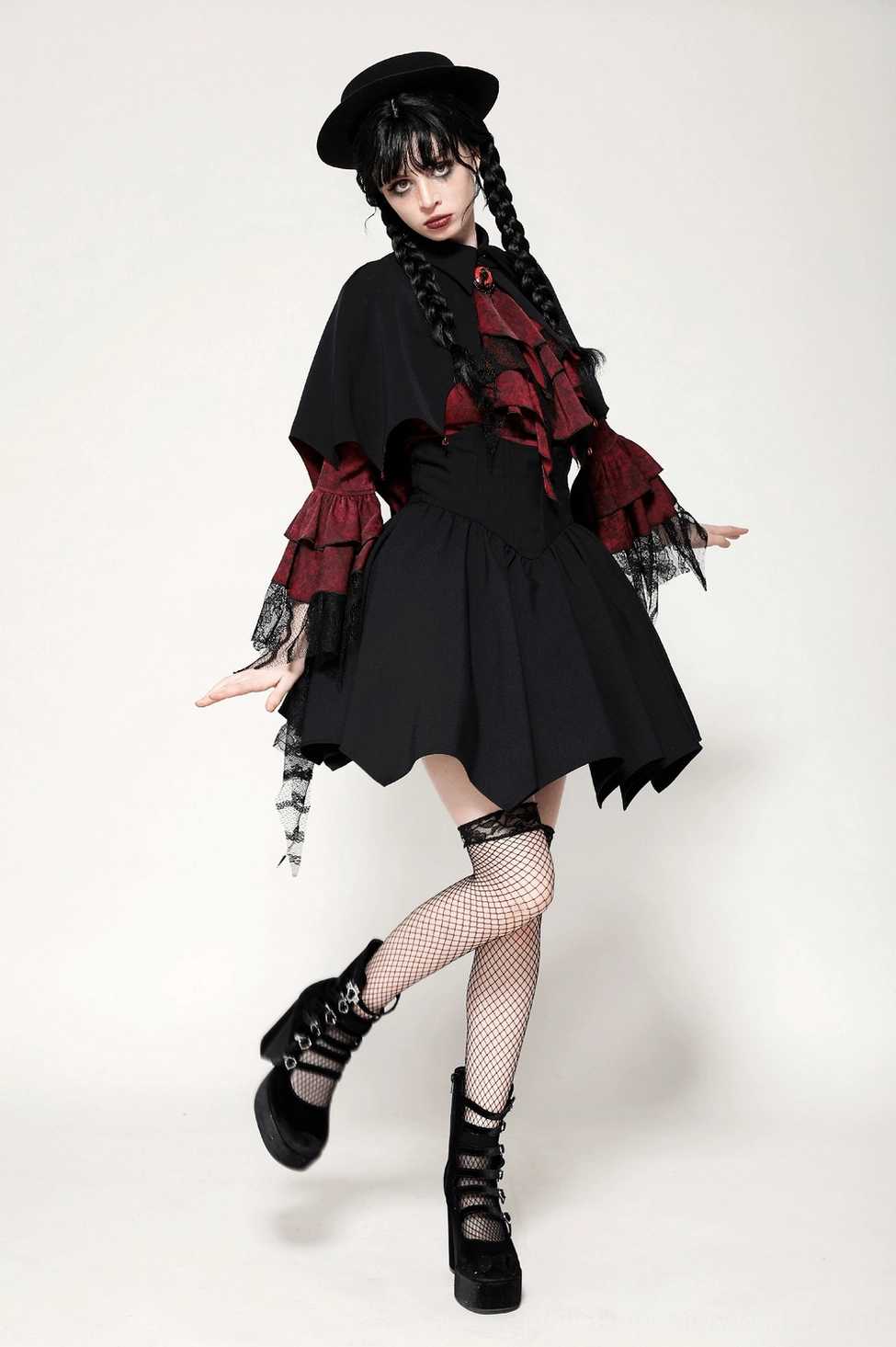 Model wearing gothic vampire cape with theatrical makeup and styling, showcasing cape's presence in complete goth aesthetic ensemble