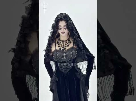Gothic cape styling reference with female model wearing black velvet hooded cape paired with corset dress for alternative fashion coordination