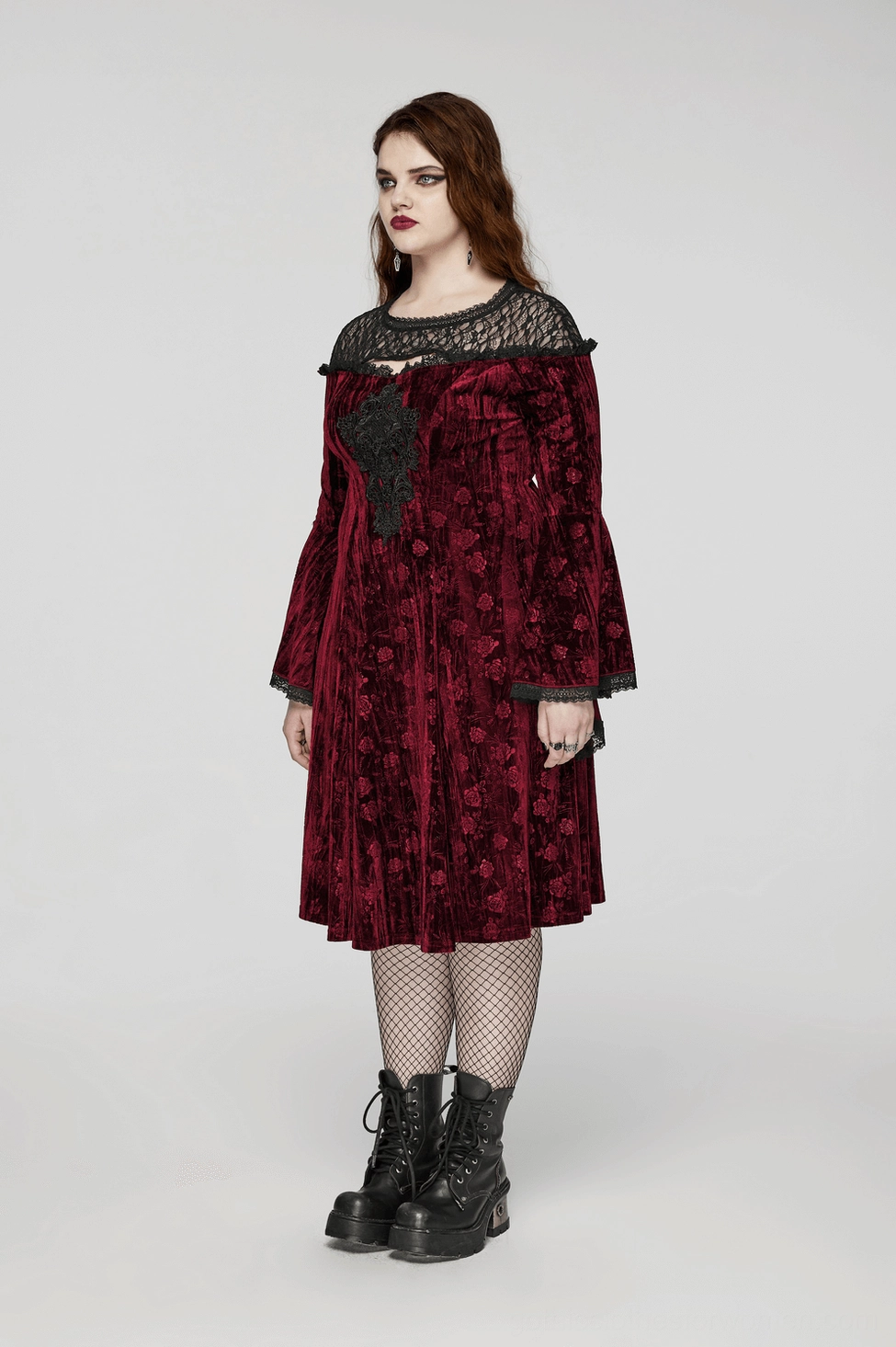 Alternative fashion styling of burgundy velvet gothic midi dress with boots and jewelry