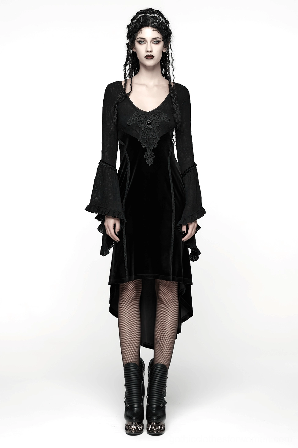 Black gothic velvet high-low dress on model showcasing bell sleeve movement and asymmetrical hemline silhouette