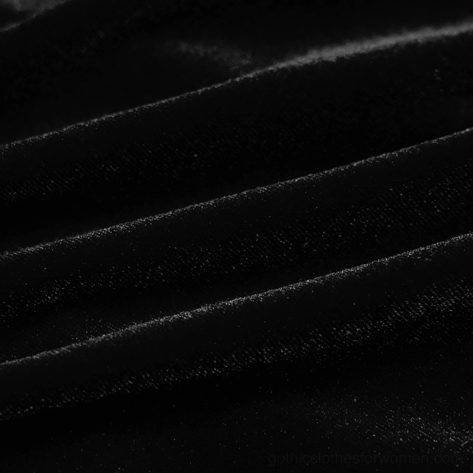 Close-up texture of soft black velvet fabric with lustrous finish on gothic dress material
