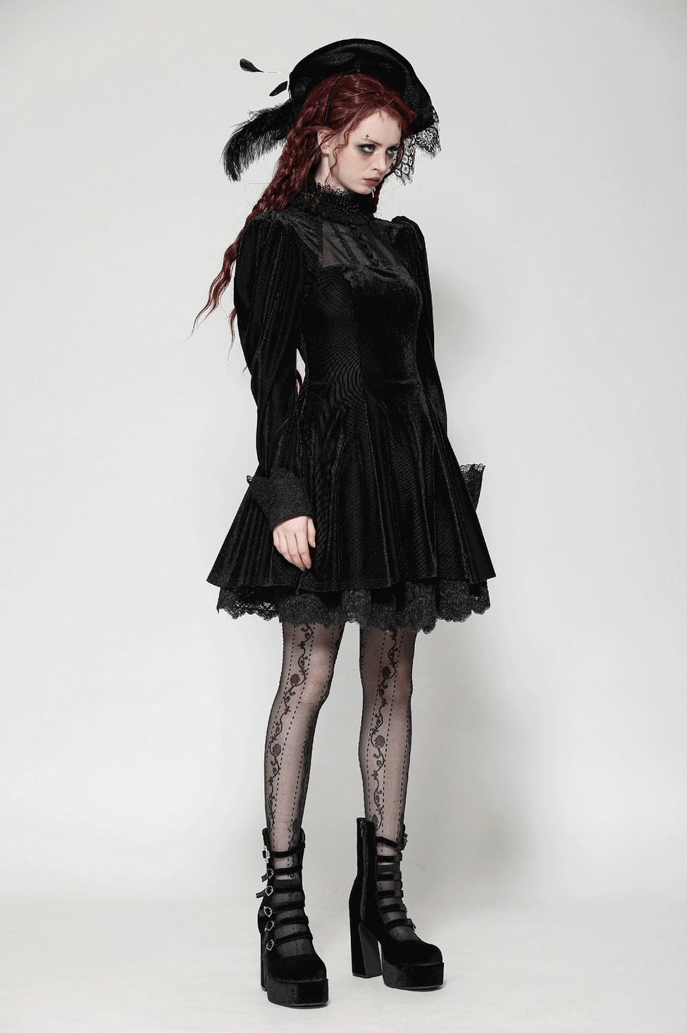 Black velvet gothic dress on hanging display highlighting puff sleeves, lace collar, flared skirt, and elegant silhouette design