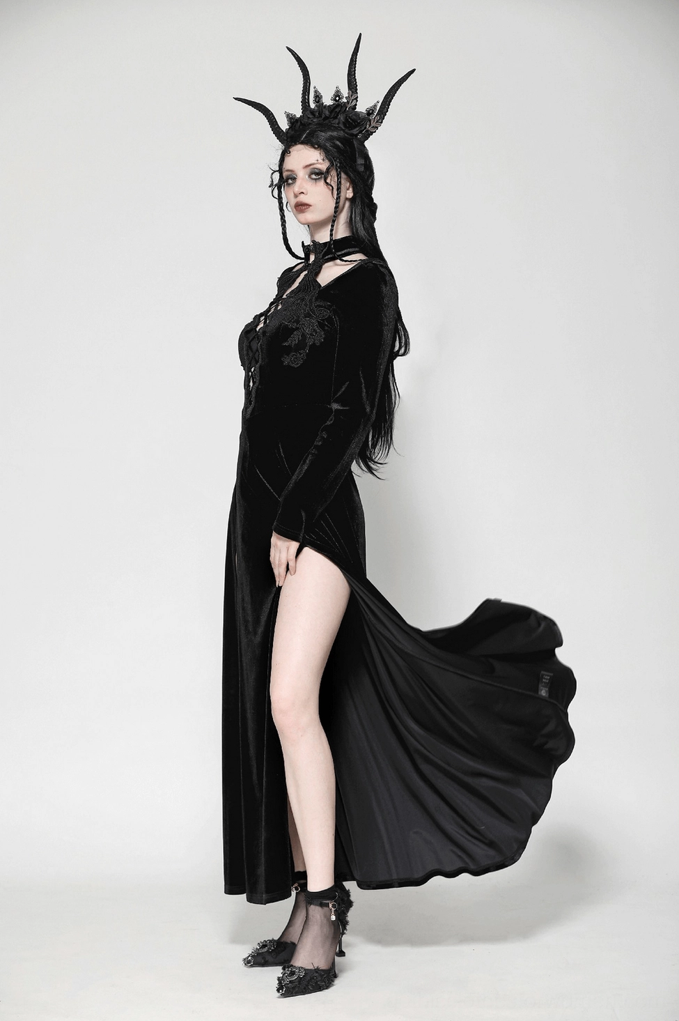 Overhead styling shot of gothic velvet dress displaying overall proportions, layering of lace elements, and design composition