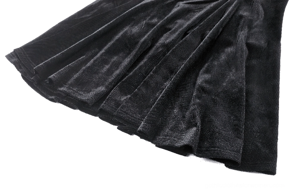 Close-up detail of black velvet gothic dress skirt showing pleated velvet fabric texture and flared mini skirt construction