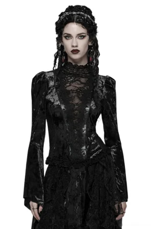 Front full-body view of black velvet lace gothic top with flared sleeves and high mock neck, worn by model with braided hair against white studio background