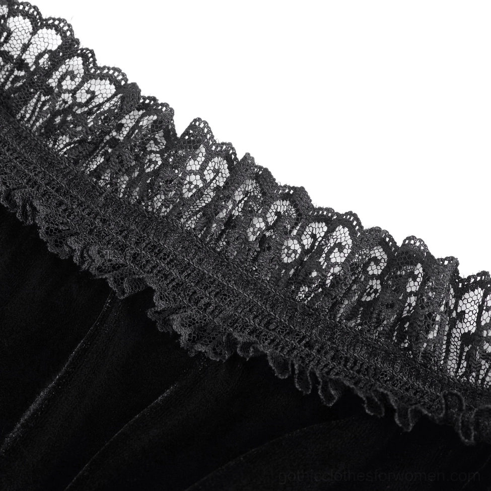 Model styling shot of black velvet gothic top with burgundy lace details and statement presentation