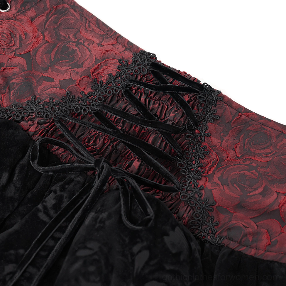 Close-up detail of velvet lace-up ties and black lace trim on gothic skirt waist