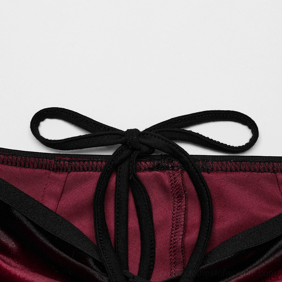Detail shot of black fabric bow waist tie on wine red gradient gothic velvet pants