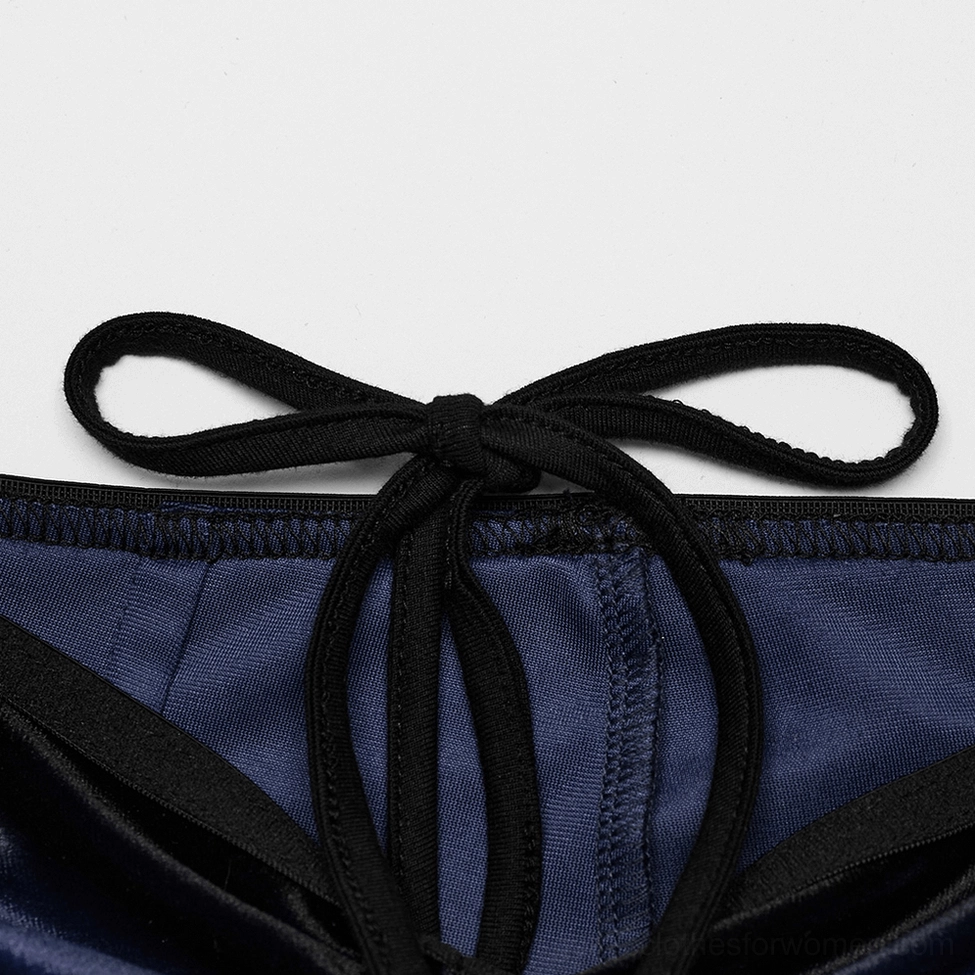 Rear view of velvet gothic pants displaying navy satin back panel and structured tie detail