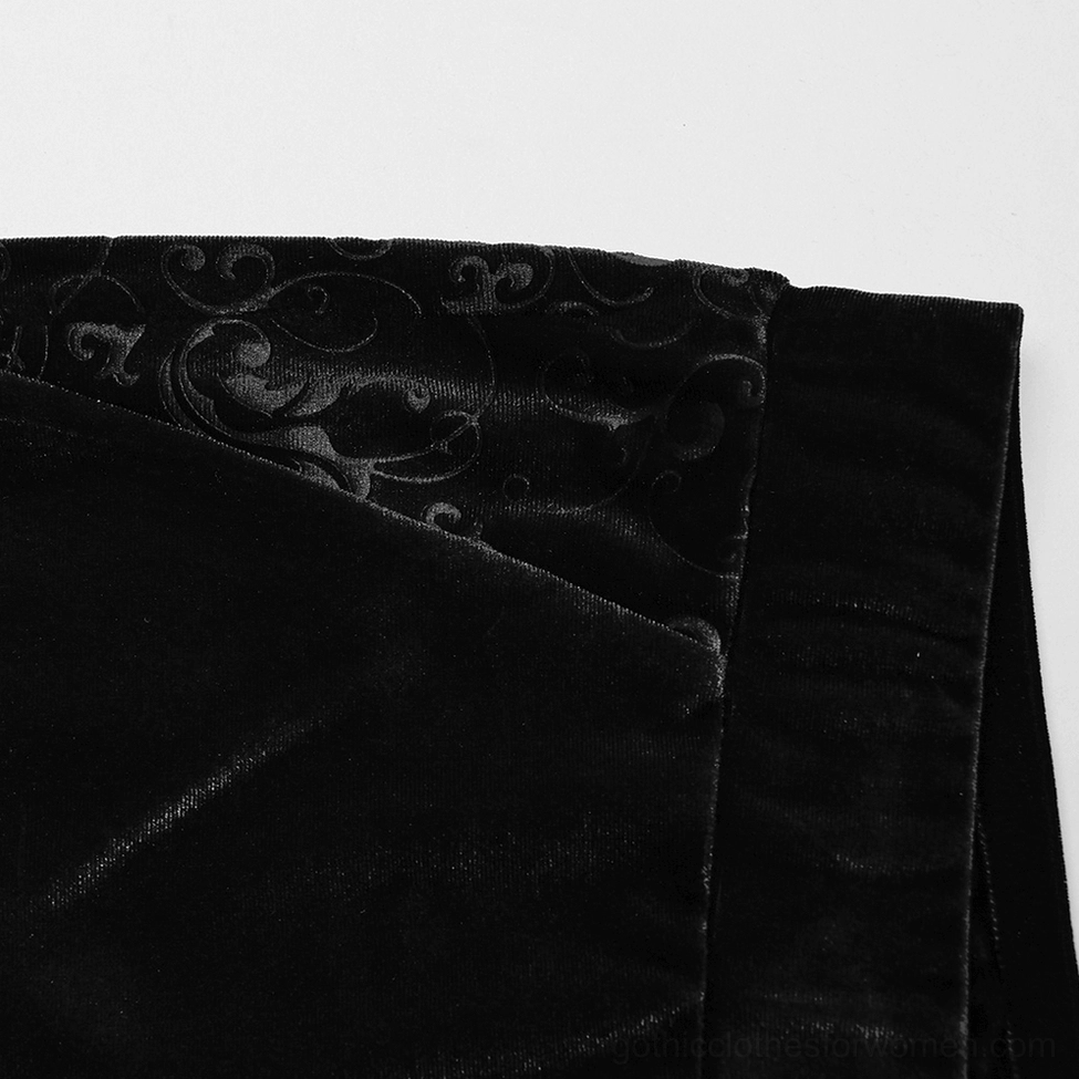 Close-up view of black velvet gothic pants side panel showing detailed baroque embossed texture and seam