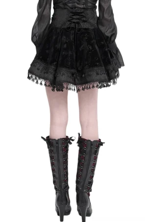 Back view of black gothic lace-up velvet skirt with rose-patterned velvet and ruffled lace tassel hem, worn with lace-up knee-high boots