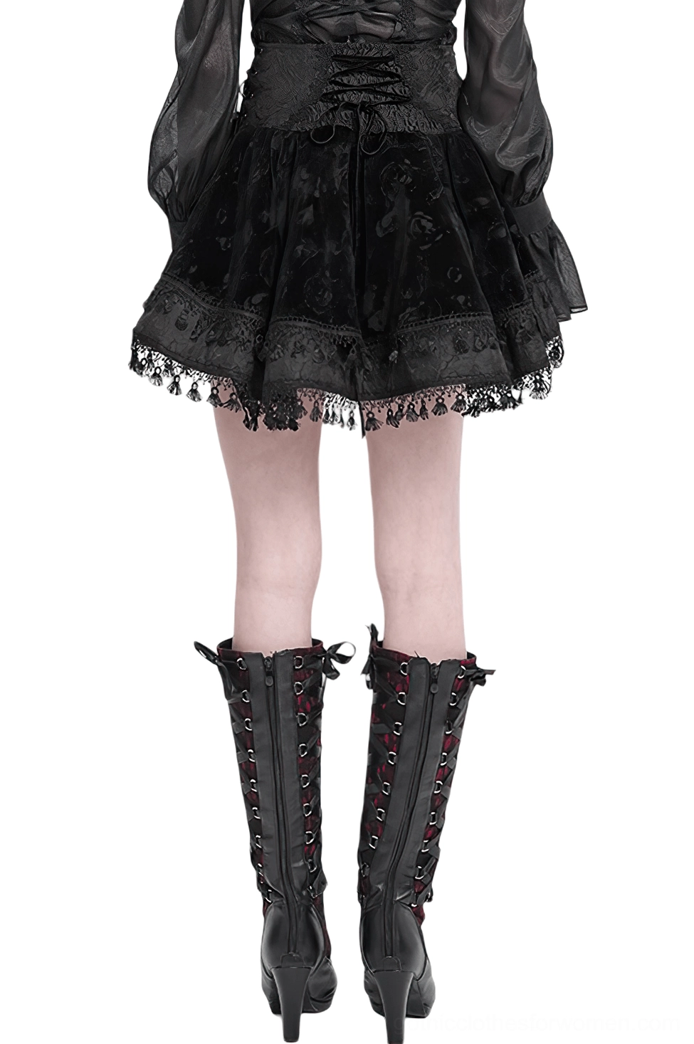 Back view of black gothic lace-up velvet skirt with rose-patterned velvet and ruffled lace tassel hem, worn with lace-up knee-high boots