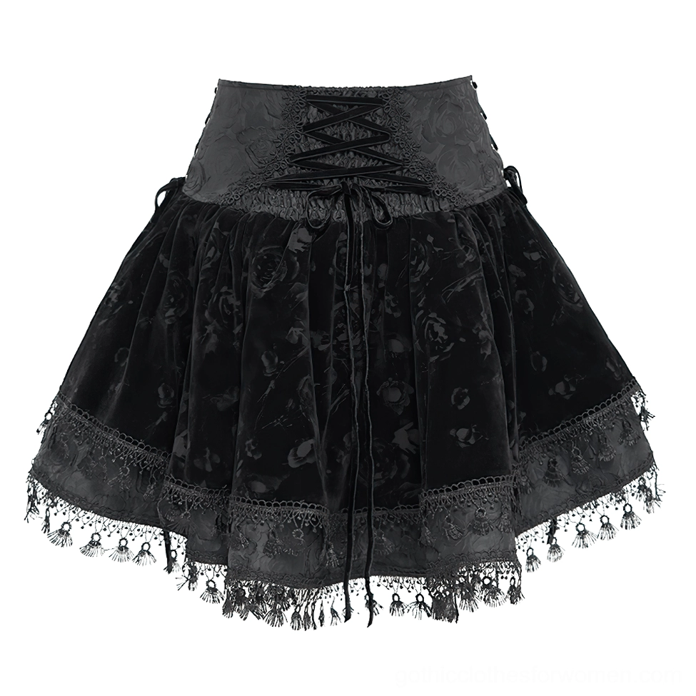 Front detailed view of black velvet gothic skirt showing front corset lace-up waist closure, embossed velvet waistband, rose pattern, and matching lace trim