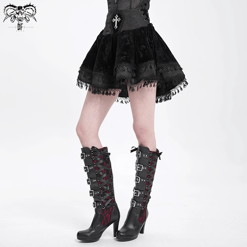 Black velvet gothic mini skirt showing front and side design details, including embroidered cross, side lace-up corset waist, and lace hem